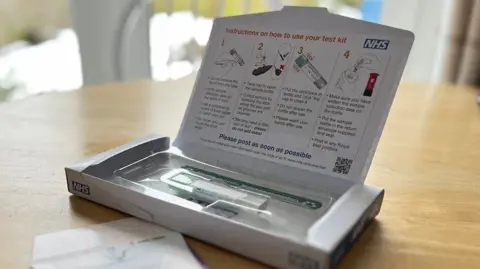 A picture of the NHS FIT kit in its postage box.