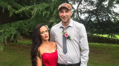 Alex Robinson A couple posing for a photo in from of