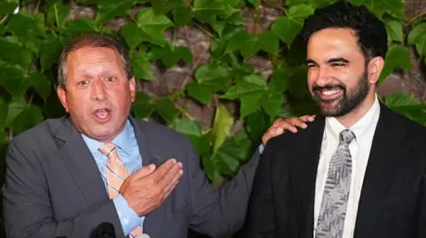 Brad Lander, candidate for New York’s 10th Congressional District, stands next to New York City Mayor Zohran Mamdani during a watch party after winning the primary elections in Brooklyn, New York