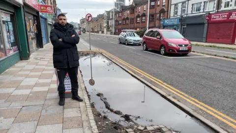 Ted Peskett / LDRS Qasim Din standing next to the rain garden