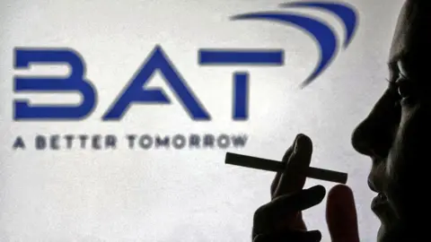 Silhouette of a person holding a cigarette in front of a dark blue BAT logo on a white background