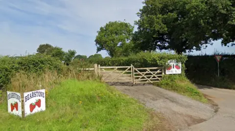 Google Maps A gate with signs advertising Bearstone fruit farm
