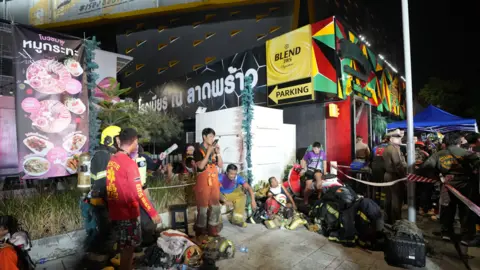 A street scene showing emergency crews on the pavement outside the venue