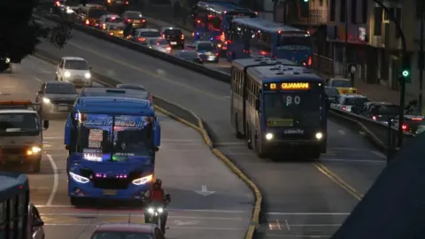 AFP Buses, cars and motorbikes travelling connected  a main   roadworthy  successful  Quito during a powerfulness  outage successful  Ecuador