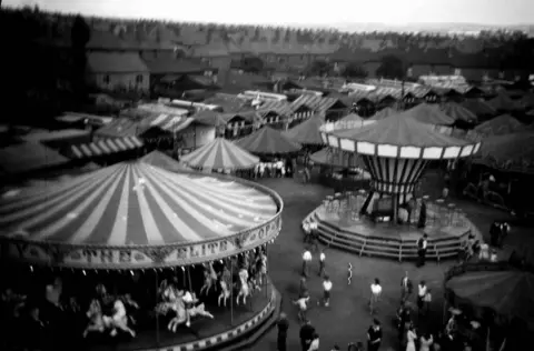 Walsall Archives An old black and white image of fairground rides in Walsall