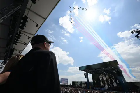 Leon Neal/Getty Images  The Red Arrows perform a fly-past 
