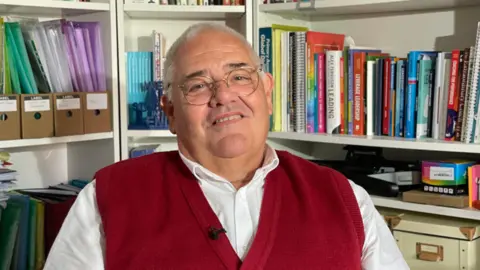 Bill Jerman in front of book shelf