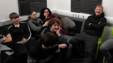 Coventry City Council A group of young students sat on a sofa with Ed Sheeran