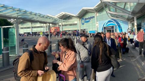 A queue outside the main terminal building at Birmingham Airport