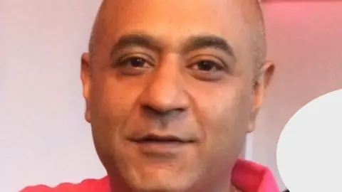 Hertfordshire Constabulary Vishal Gohel, looking at the camera. He is wearing a red top. 