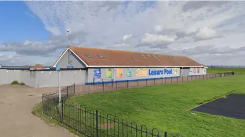 The outside of a lido, located in a large open space.