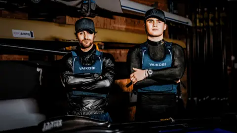 Mission Memory Ben Watkins and Oliver Smee in kayaking gear with their arms crossed.