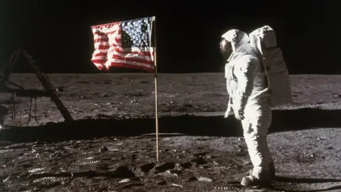 Getty Images Astronaut Buzz Aldrin stands beside an American flag placed on the moon during Apollo 11 extravehicular activity, 1969
