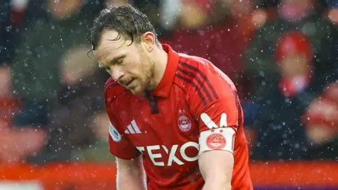 Aberdeen's Nicky Devlin looks dejected at full time during a William Hill Premiership match between Aberdeen and Dundee at Pittodrie Stadium, on February 21, 2026, in Aberdeen, Scotland.