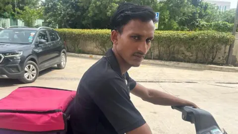 Priti Gupta Vineet Sawant sits on his scooter