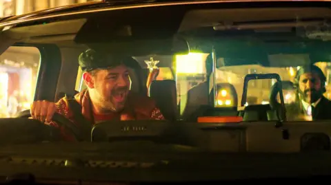Christmas Karma Danny Dyer and Kunal Nayyar in a black cab in Christmas Karma