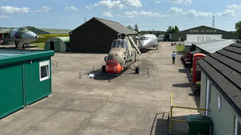 Newark Air Museum External shot of Newark Air Museum showing aircraft parked on concrete areas, with single storey utilitarian buildings spread across the area