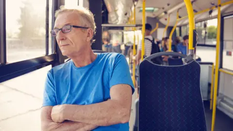 Getty Images/izusek Elderly man traveling in bus (stock photo)