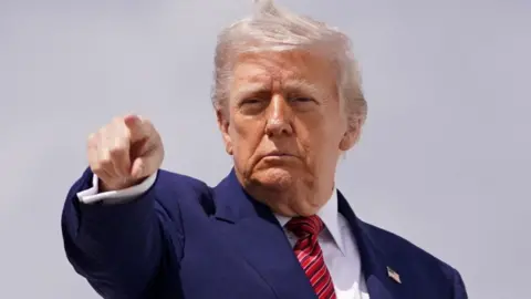 Donald Trump gestures as he boards Air Force One en route to New Jersey, at Joint Base Andrews, Maryland, U.S., May 23, 2025. 