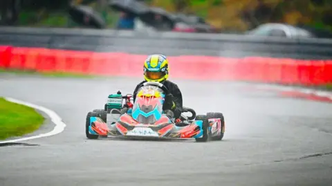 Jake Smith A motorsport photograph, a rider is going round a corner on a motorcart.