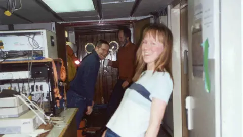 National Oceanography Centre An old picture of Prof Holliday and two men leaning over whilst on board discovery.