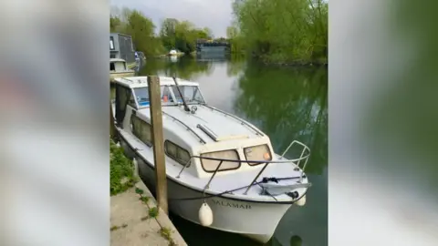 Andy Ellison A Freeman boat, called Salamar, moored on the River Thames in calmer waters 