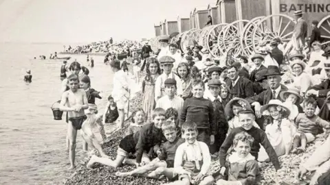 The Regency Society A black and white image of a large group of children on Brighton beach. 