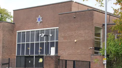 Exterior of Heaton Park Hebrew Congregation synagogue with its distinctive Star Of David window filled with its distinctive blue glass Star of David Window.