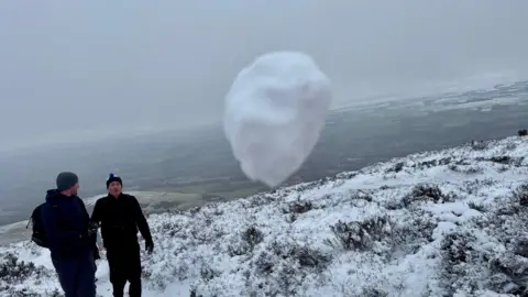 Julia Haase-Wilson Snow covered grass and overcast skies, with a snowball dead centre in the image as it heads towards the camera