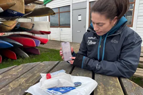 Beth Gill demonstrating the online map where results from community sampling are displayed