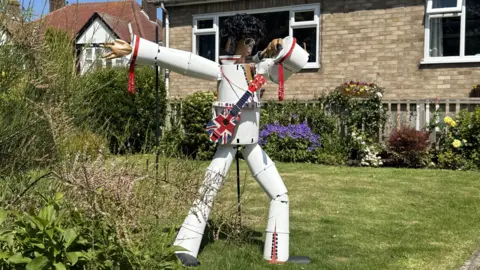 BBC/Amber Gash A statue made of flowerpots depicting the singer Elvis Presley. The statue features a white coloured jumpsuit and a guitar.