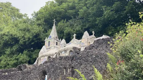 BBC Guernsey's little chapel. It is a small building set in a rock with shells and pot making up the rock