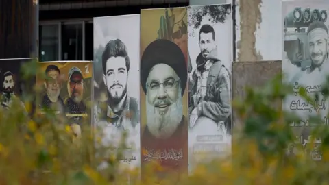 A poster showing the late Hezbollah leader Hassan Nasrallah and slain fighters from the Lebanese armed group in the southern Lebanese city of Tyre