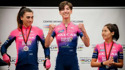Getty Images Yulduz and Fariba stand on a podium after a race