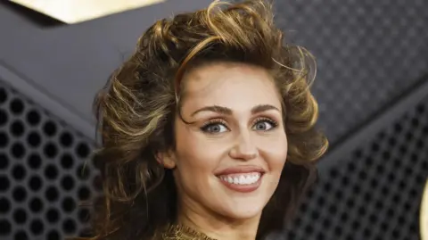  EPA-EFE/REX/Shutterstock Miley Cyrus, facing camera, arrives for the 66th annual Grammy Awards ceremony in Los Angeles February 2024