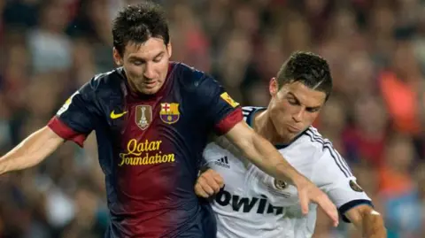 Cristiano Ronaldo playing for Real Madrid and Lionel Messi in action for Barcelona