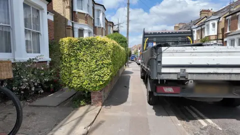 A van parked on a pavement.