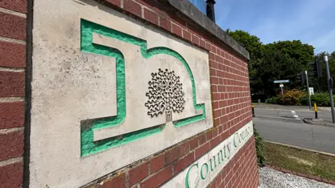 A Nottinghamshire County Council sign on a red-brick wall
