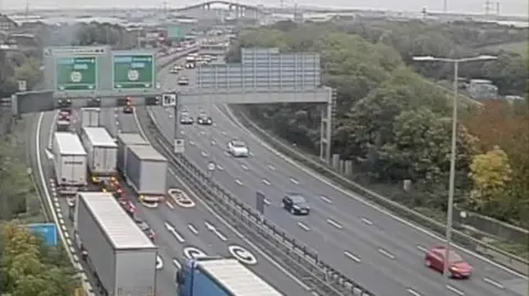 A bird's eye view of traffic build up on the M25 approach to the Dartford Crossing, with the Queen Elizabeth II Bridge visible in the distance.