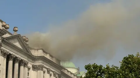 PA Media Smoke billows from the roof of Somerset House 