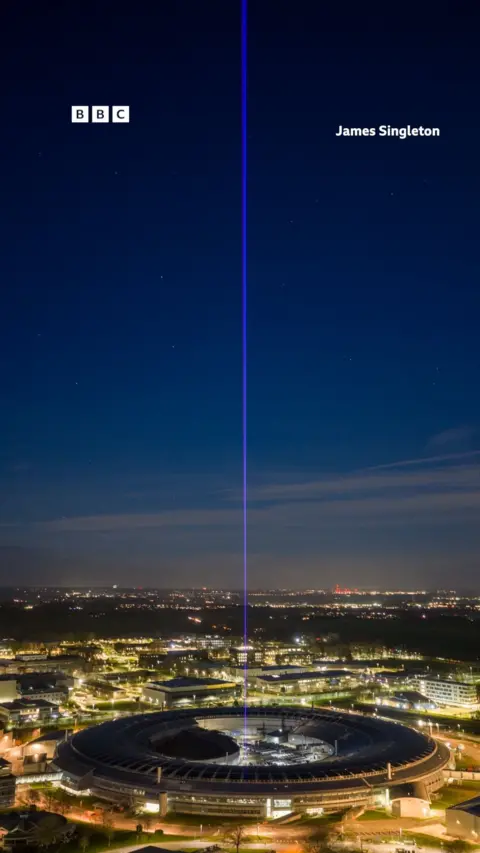 A beam of light shines into the night sky.