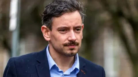 JASPERIMAGE Sean Morton wearing a blue suit over a lighter blue shirt.