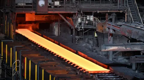 Getty Images Steel moving along rollers at the hot rolling a Nippon Steel facility in Japan.