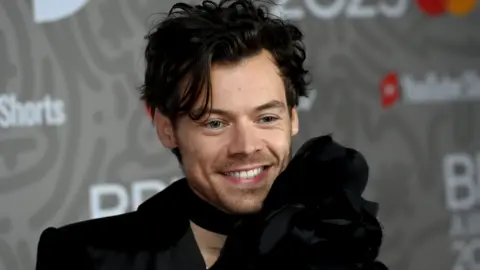 Getty Images Harry Styles posing for a photograph