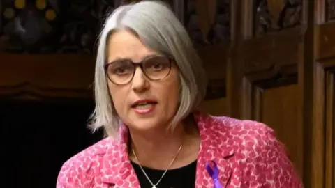 House of Commons A woman in a pink suit with a grey bob