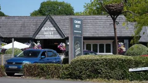 BBC The Crow's Nest Pub exterior with a car parked in front of the entrance.
