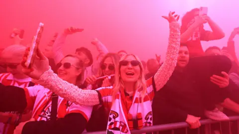 Matt Watson/Southampton FC/Getty Southampton fans welcome their team amidst thick red smoke