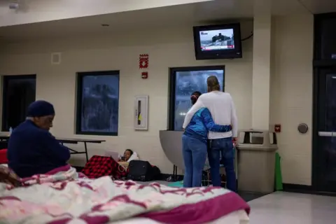 Reuters Evacuees at an emergency shelter in Florida wait for news