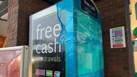 Cash machine at Esso petrol station on Tong Street in Bradford. People tried to break the machine open to steal cash
