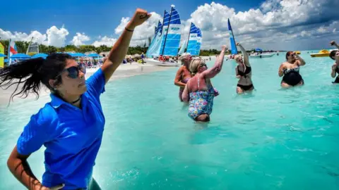 Getty Images Canadian tourists taking part in an exercise class in the sea off a beach in Varadero, Cuba